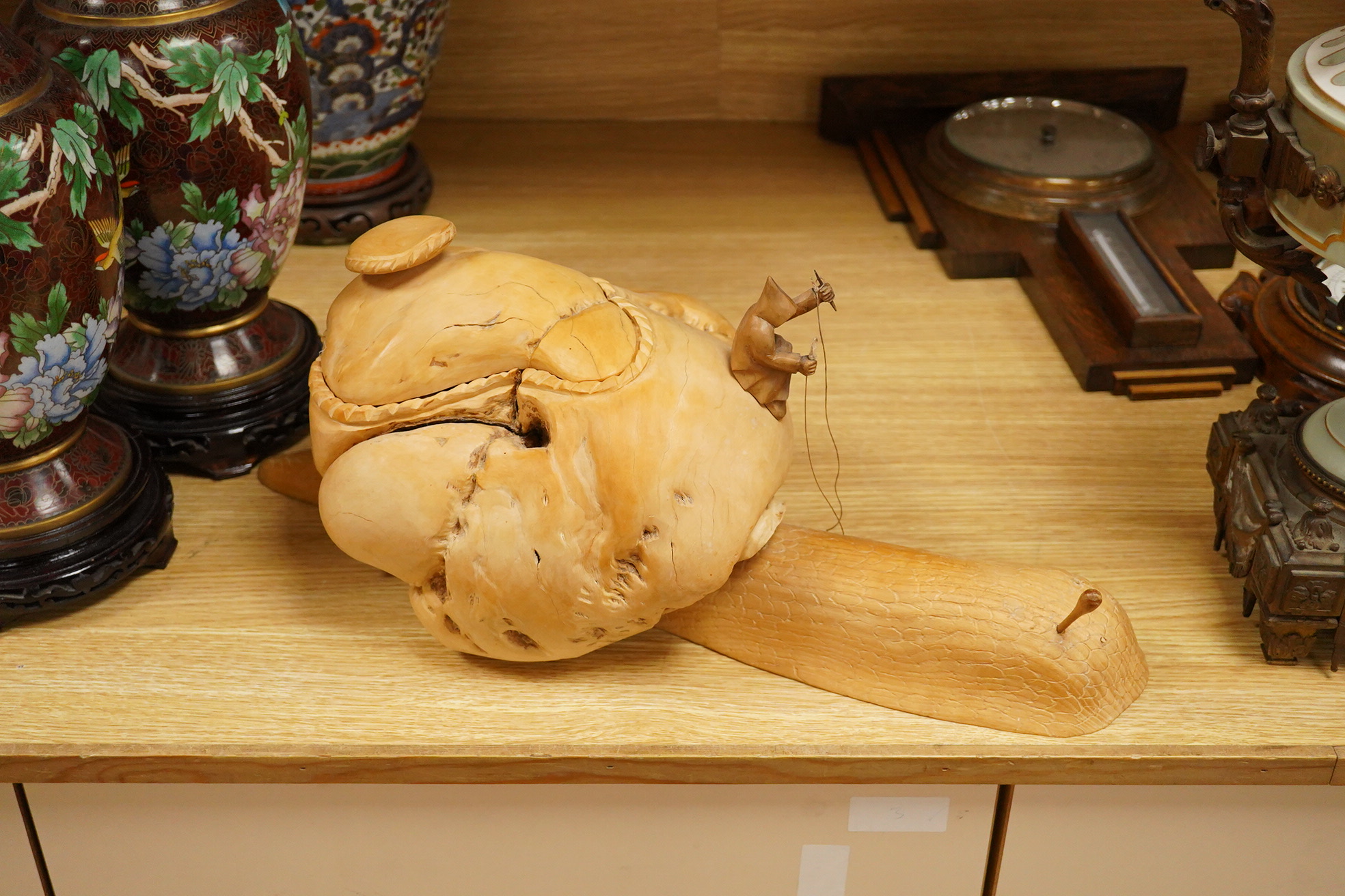 Pierre Decorse (b.1953), a naturalistically modelled wooden sculpture depicting a figure riding a snail, 53cm long